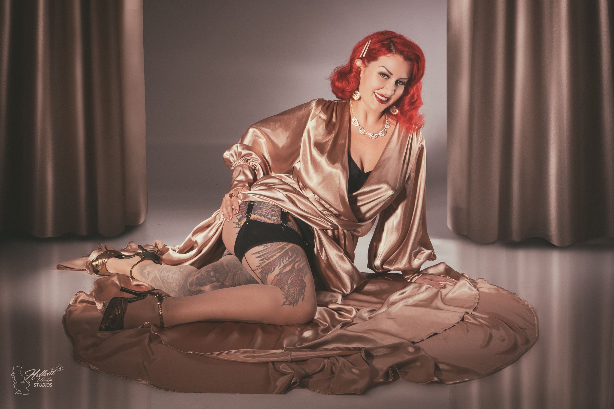 a woman with red hair sitting on the floor.