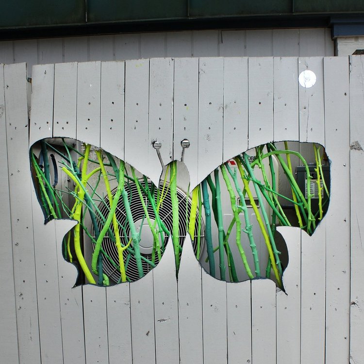 a butterfly is painted on a white wall.