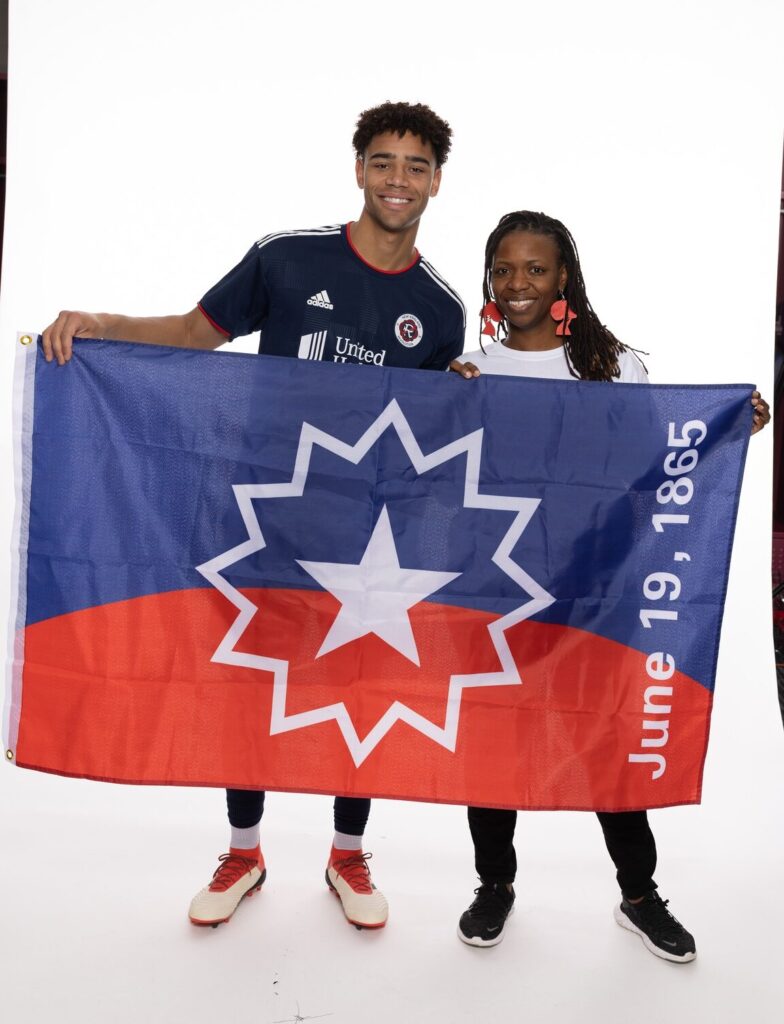 a man and a woman holding a flag.