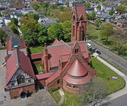 an aerial view of a church in a city.