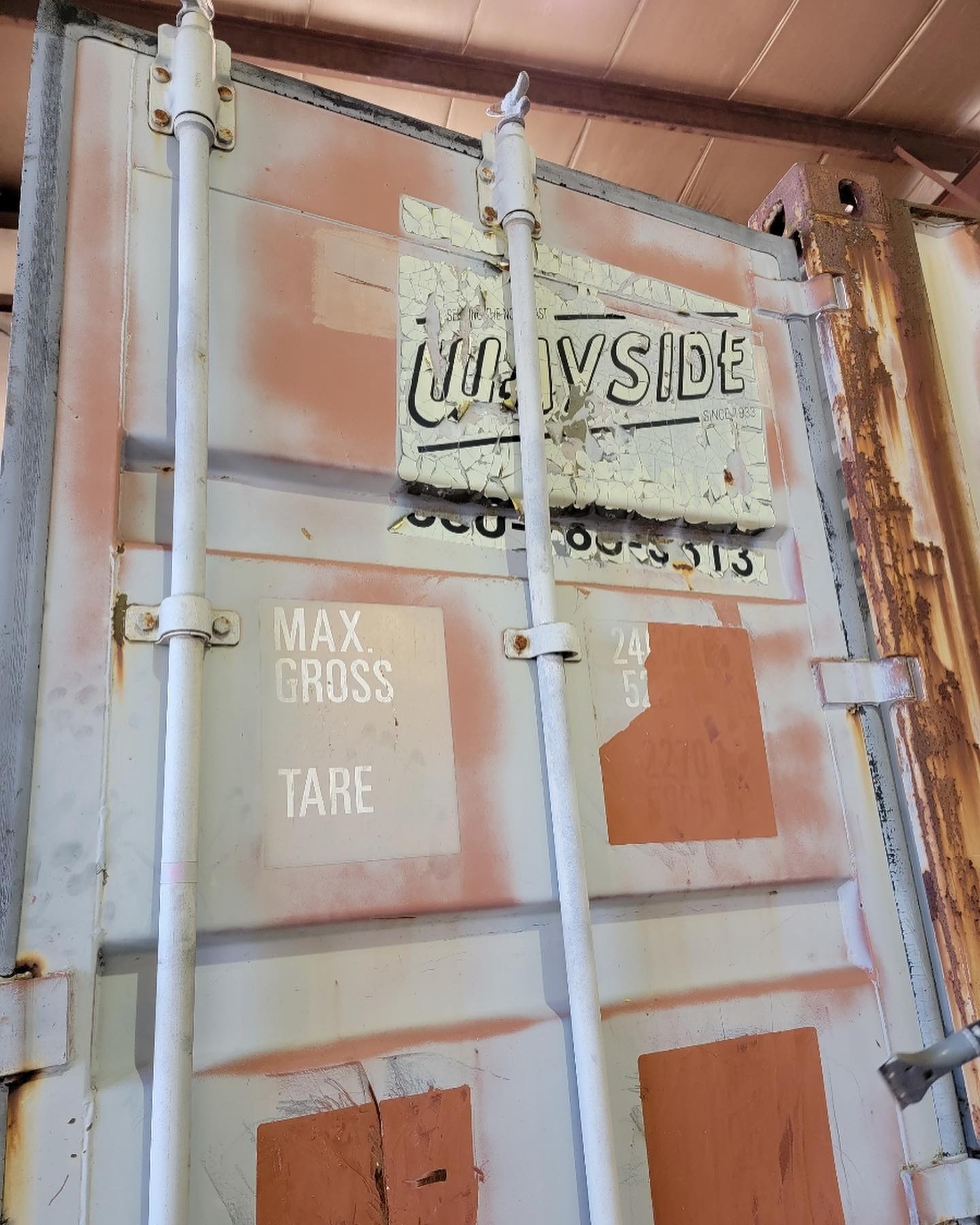 A rusty container with a sign on it.