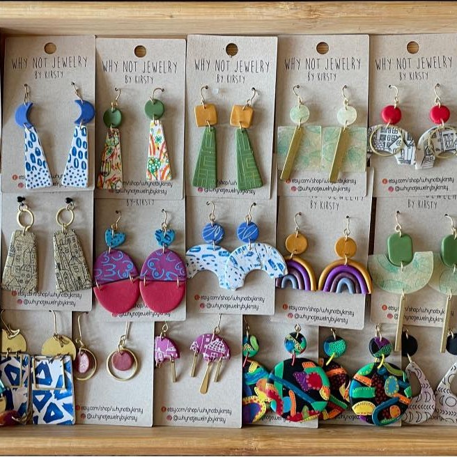 An exquisite collection of handmade earrings showcased in a charming wooden box, perfect for Small Business Saturday shoppers.