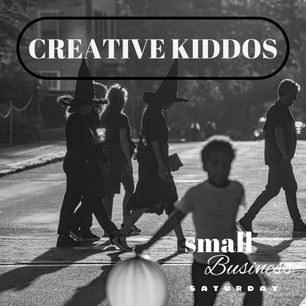 A black and white photo of people walking down the street with the words creative kiddos.