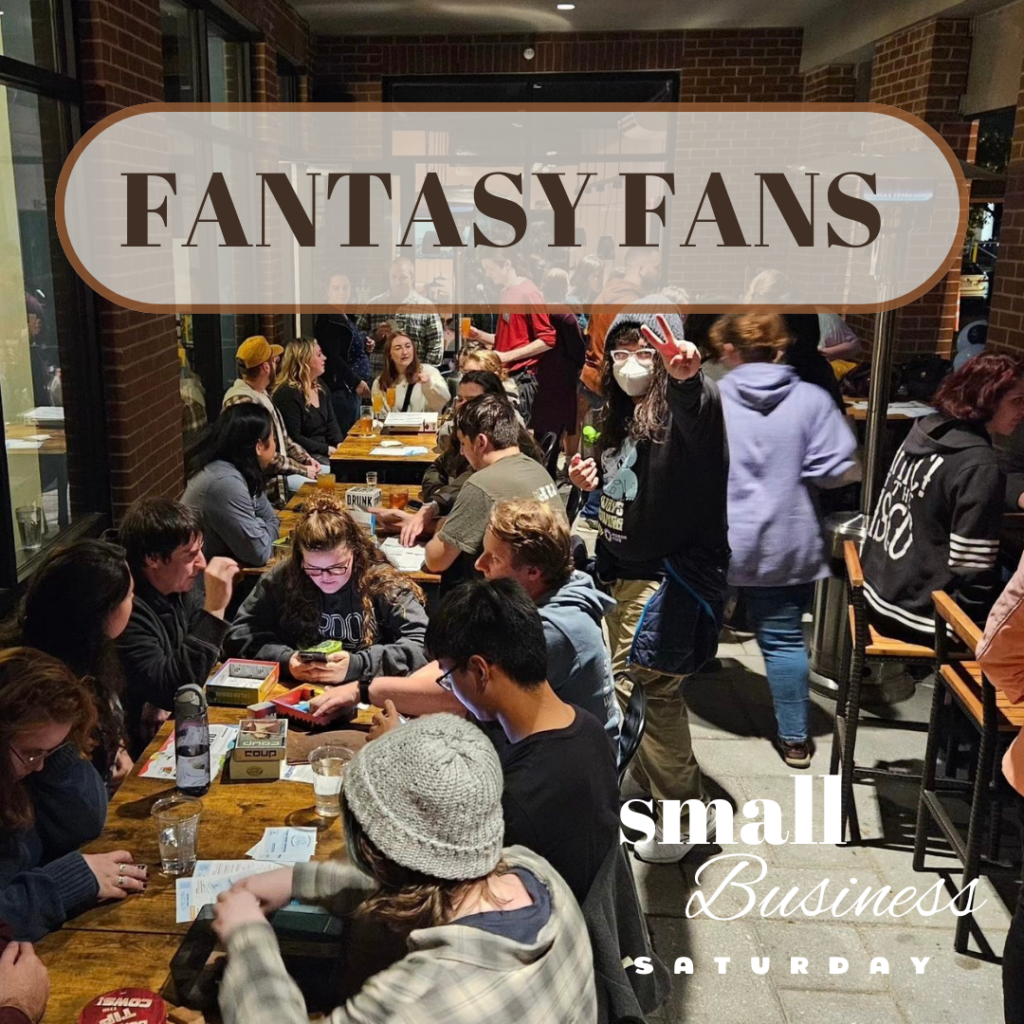 A group of people at a table with the words fantasy fans.
