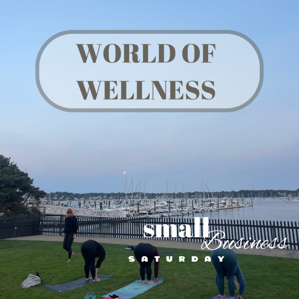 A group of people doing yoga in the grass with the words world of wellness.