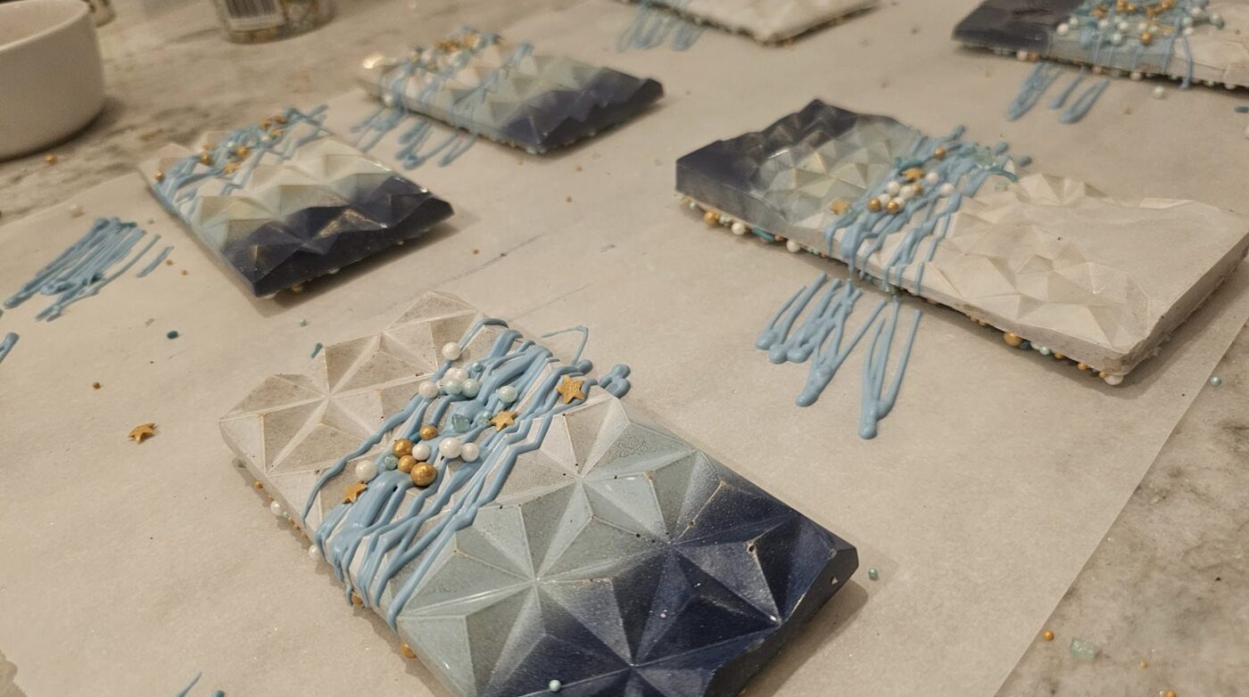 An assortment of blue and white chocolate bars displayed on a table.