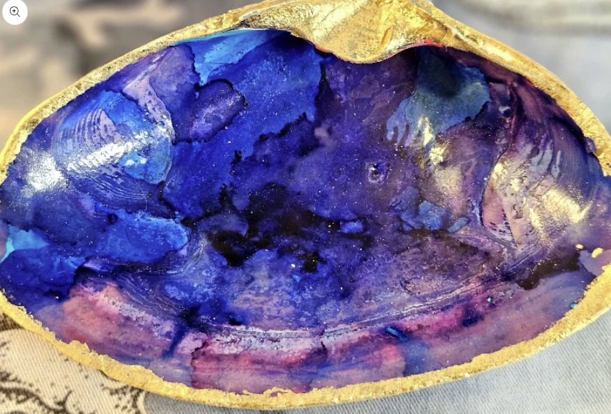 A vibrant, blue and purple bowl displayed on a table.