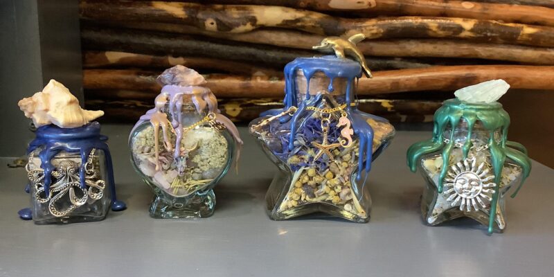 Check out these four unique glass bottles, beautifully shaped like octopuses. Perfect for any table setting.