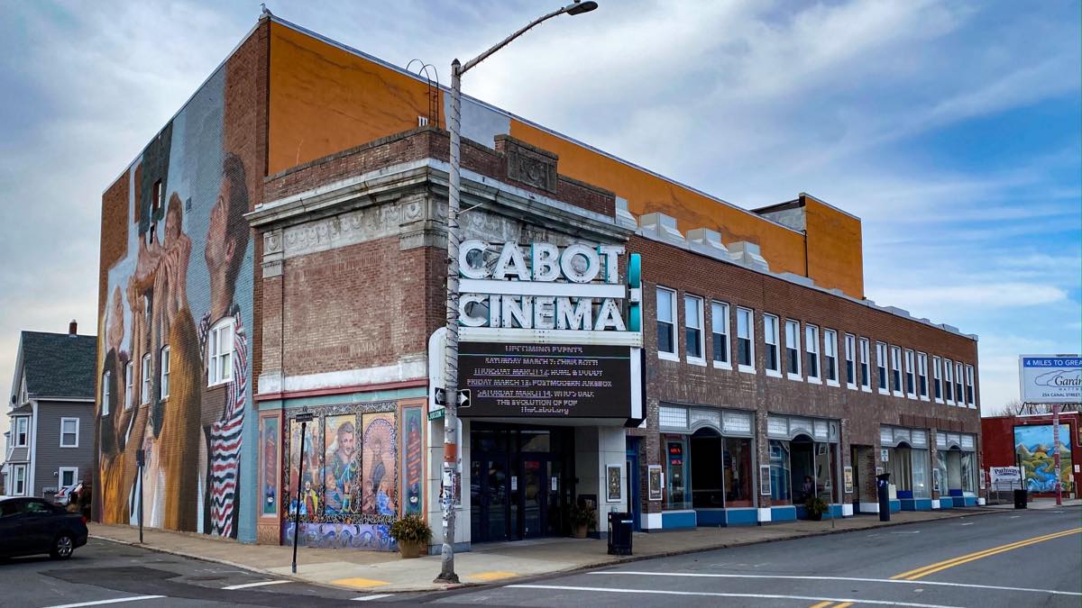 Discover the iconic Cabot Cinema, featuring a stunning mural gracing the side of its building. Set against an ever-changing backdrop of cloudy skies, it's an immersive piece of history awaiting your visit.