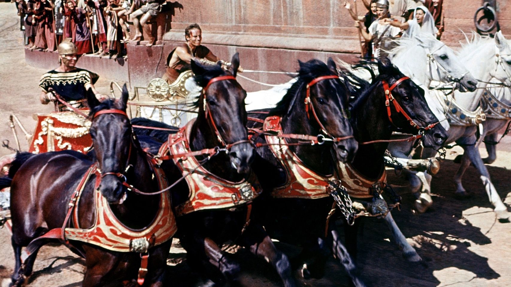 Exhilarating scene of a traditional chariot race, featuring horses and costumed riders reminiscent of historical times.