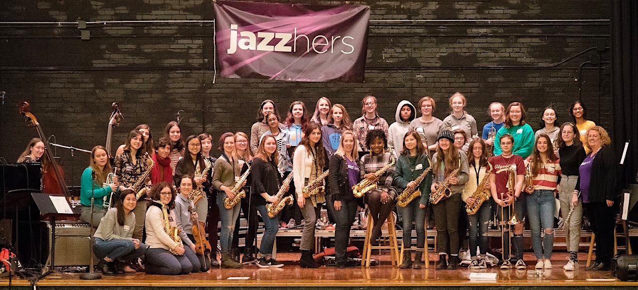 Women musicians posing for a picture at a jazz band event.