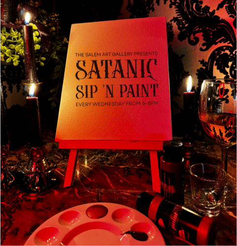 Join us for an enchanting "Satanic Sip n Paint" experience at Salem Art Gallery. Be captivated by our strikingly unique set-up, complete with a sign, warm glowing candles and high-quality paint tools perfectly laid out on a table against a visually striking red and black backdrop. Indulge in this immersive art event as you sip your favorite brew, and let your creativity run free in the magical ambience. Unleash the artist within you only at Salem Art Gallery — where every stroke tells a bewitching tale.