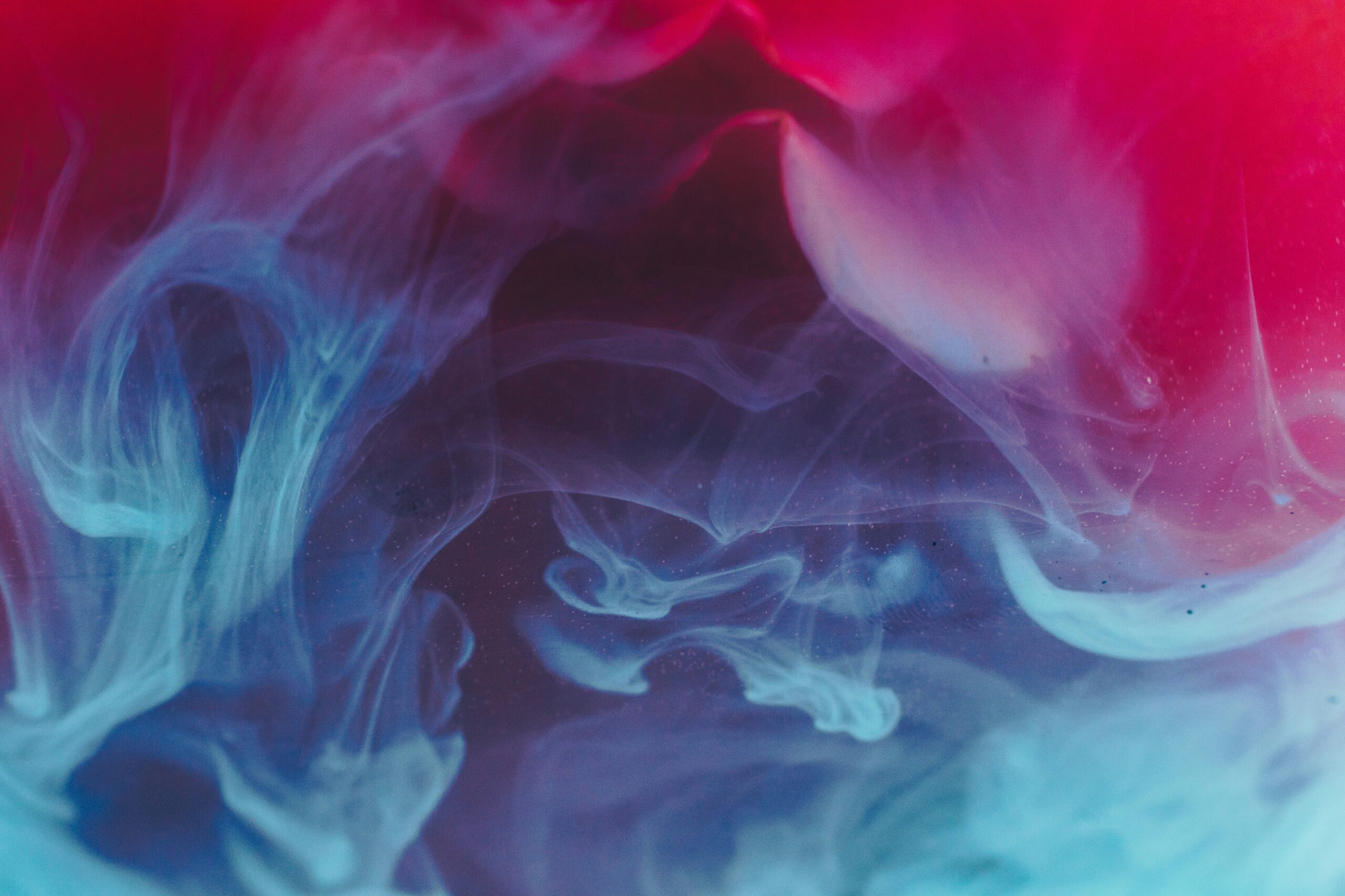 Celebrate 4/20 with a mesmerizing image of red and blue smoke swirls. The design creates an entrancing fluid pattern against a dark backdrop, perfect for promoting relaxation and awe.