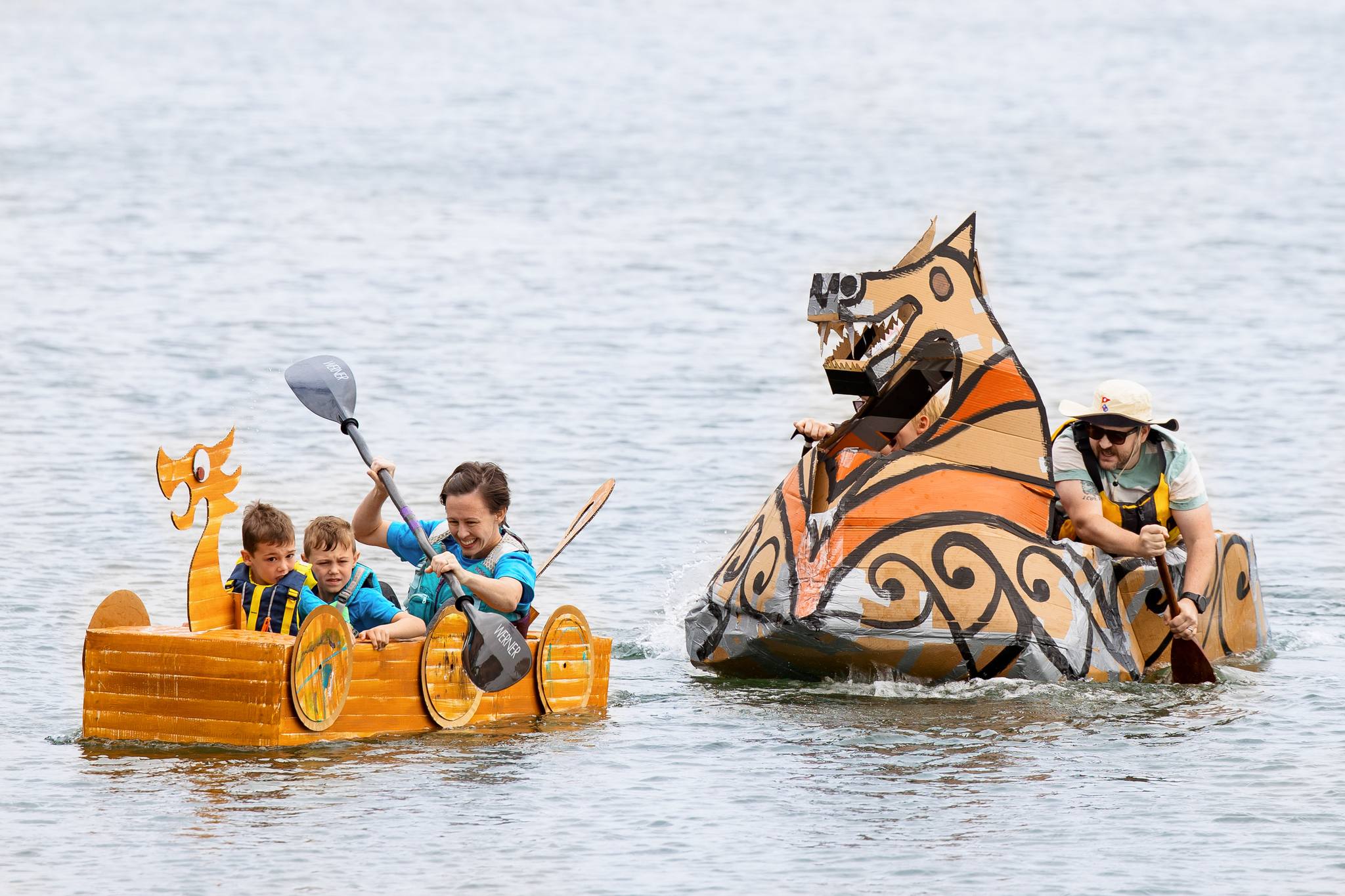 Three locals paddle a lively cardboard Viking ship as another steers a dragon boat—Essex County’s creative spirit shines at our community event.