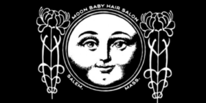 Discover the charming monochrome logo of Moon Baby Hair Salon in Salem, Mass. It showcases a cheerful moon face embraced by elegant floral designs.