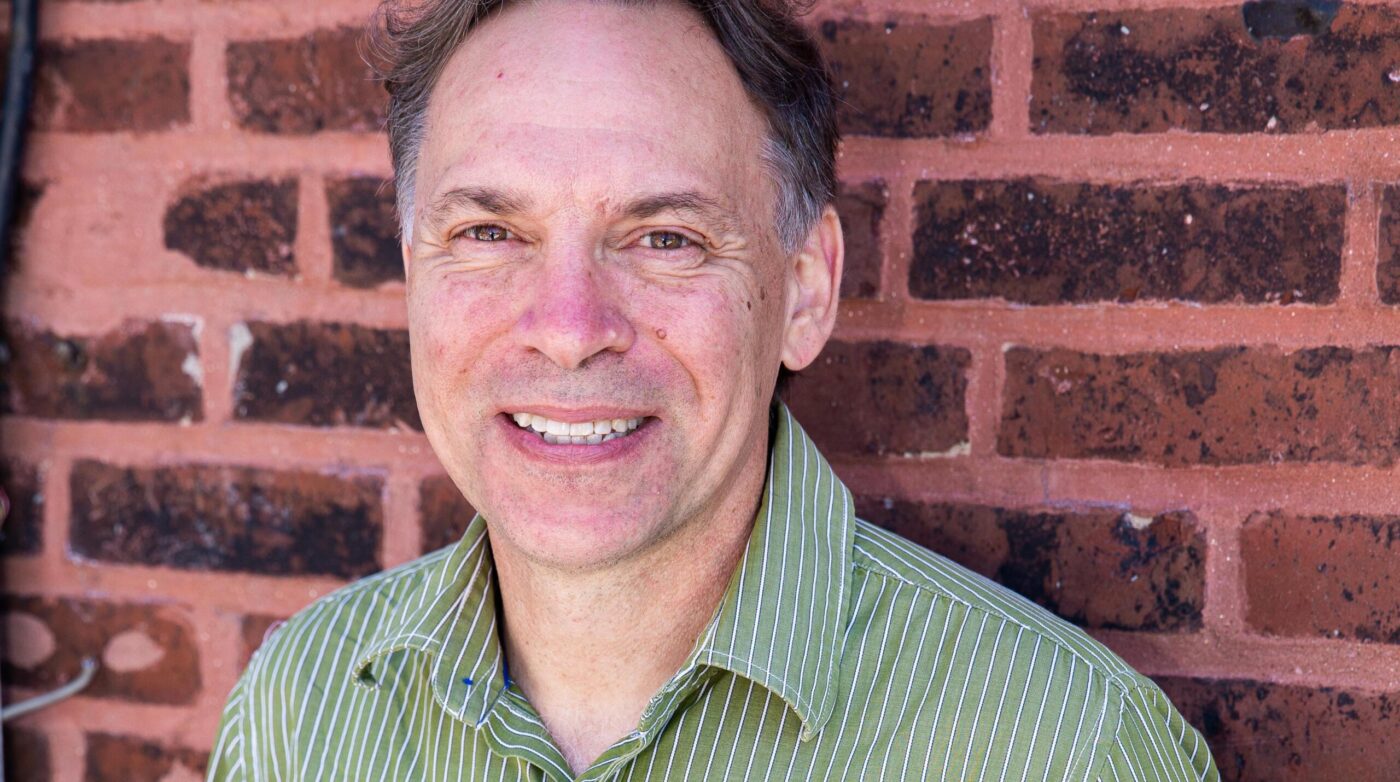 Capture attention with a striking image: a cheerful man sporting a green striped shirt against a classic brick wall backdrop. This simple yet engaging visual eliminates corporate jargon while inviting viewers to connect on a personal level. Perfect for grabbing attention and leaving an impression!