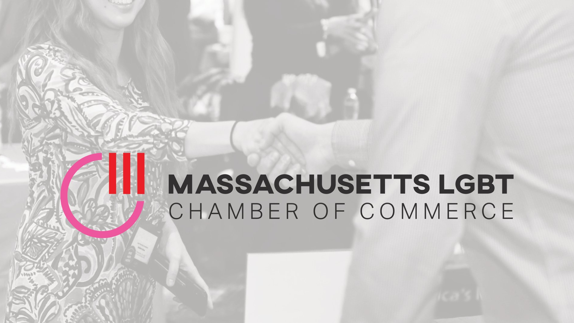 Two people warmly shake hands as the Massachusetts LGBT Chamber of Commerce logo stands out in the foreground, highlighting a spirit of unity and collaboration.