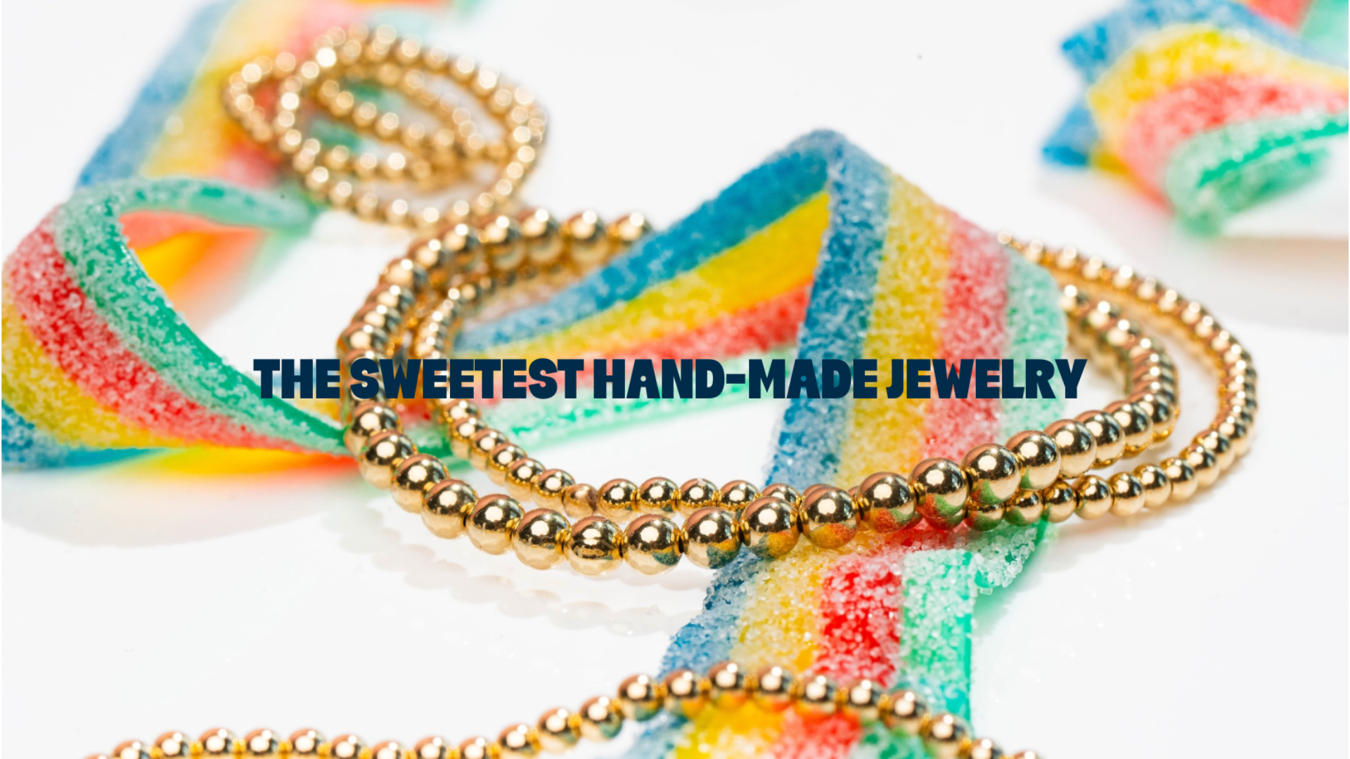 Discover the Charm of Hand-Made Jewelry: Vibrant Candy Strips and a Dazzling Gold Bead Necklace.