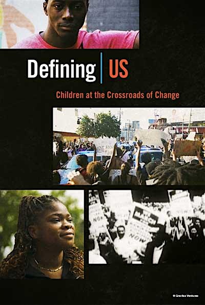 The movie poster for "Defining US: Children at the Crossroads of Change" features compelling images of a young man, a young woman, and protestors holding up signs. Bold lettering draws attention to the film’s title and message, making it clear that the documentary explores youth experiences and social change.