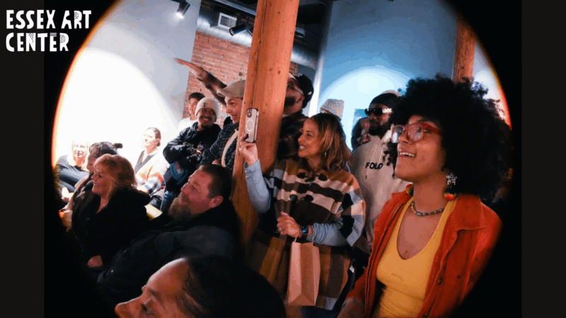 A joyful crowd—neighbors and friends—smile, snap photos, and share in the creative buzz at our Essex Art Center event.