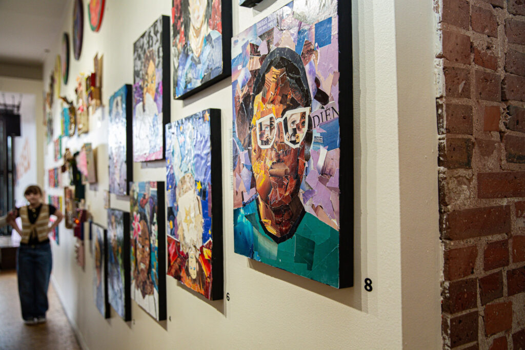 Our lively gallery wall bursts with mixed-media portraits by local artists