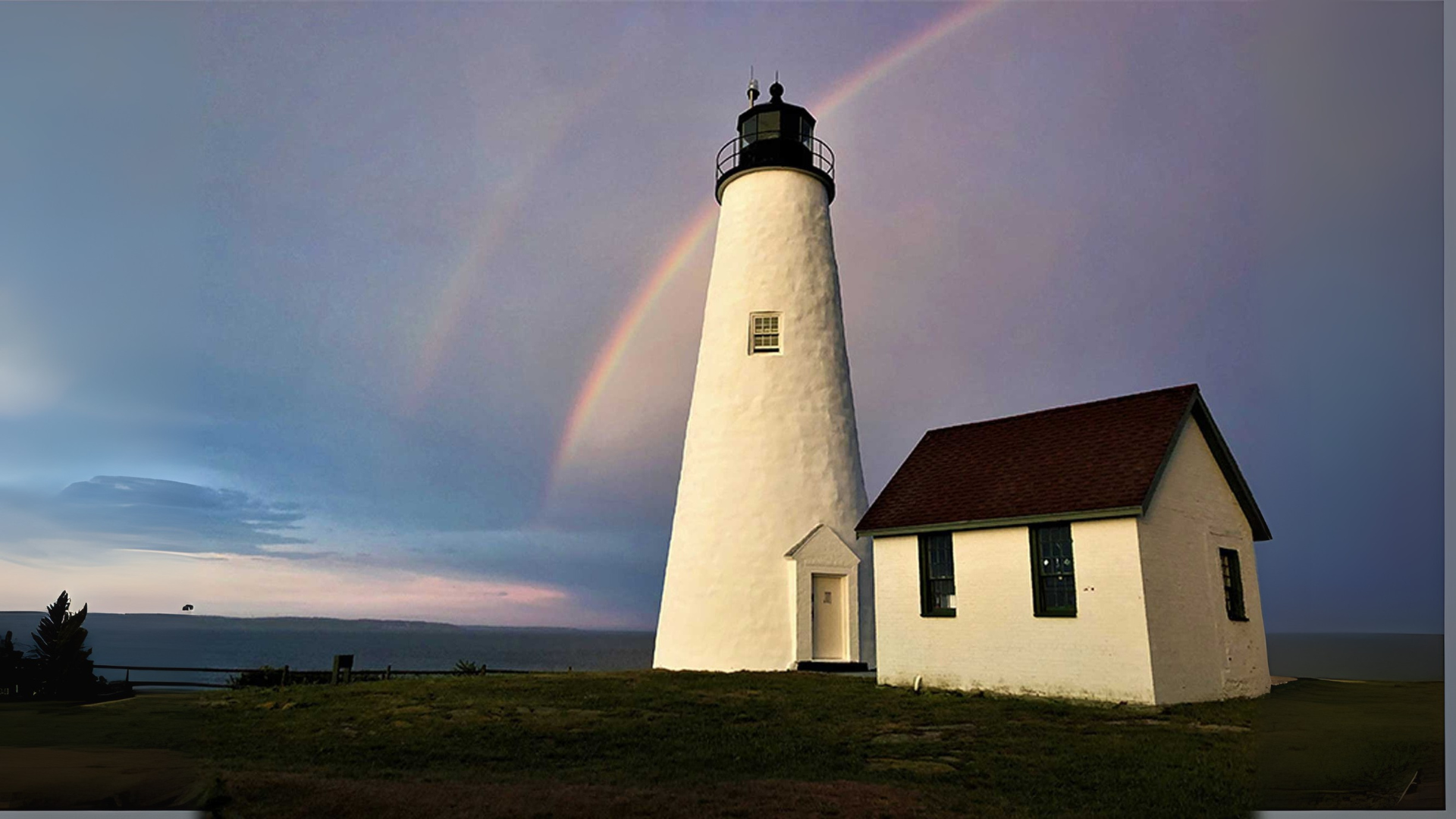 Iconic white lighthouse in Salem glows by sunset waters as a bold rainbow arcs above—our creative spirit shining bright together.