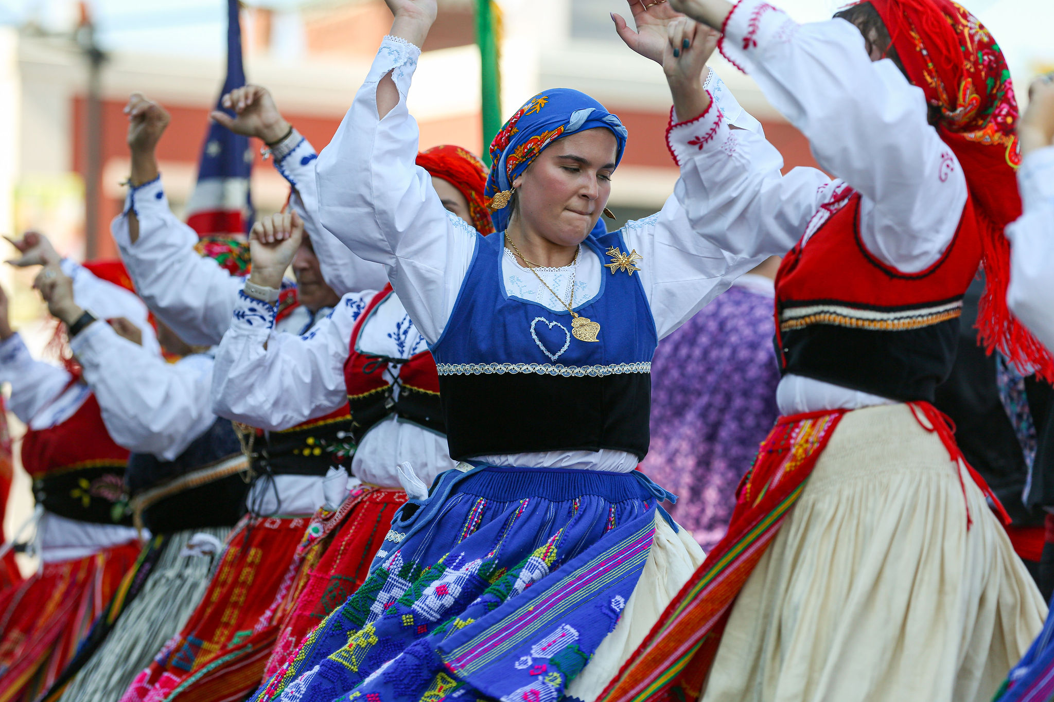 Vibrant dancers in colorful, embroidered attire celebrate heritage together at Peabody International Festival 2025 in Essex County.