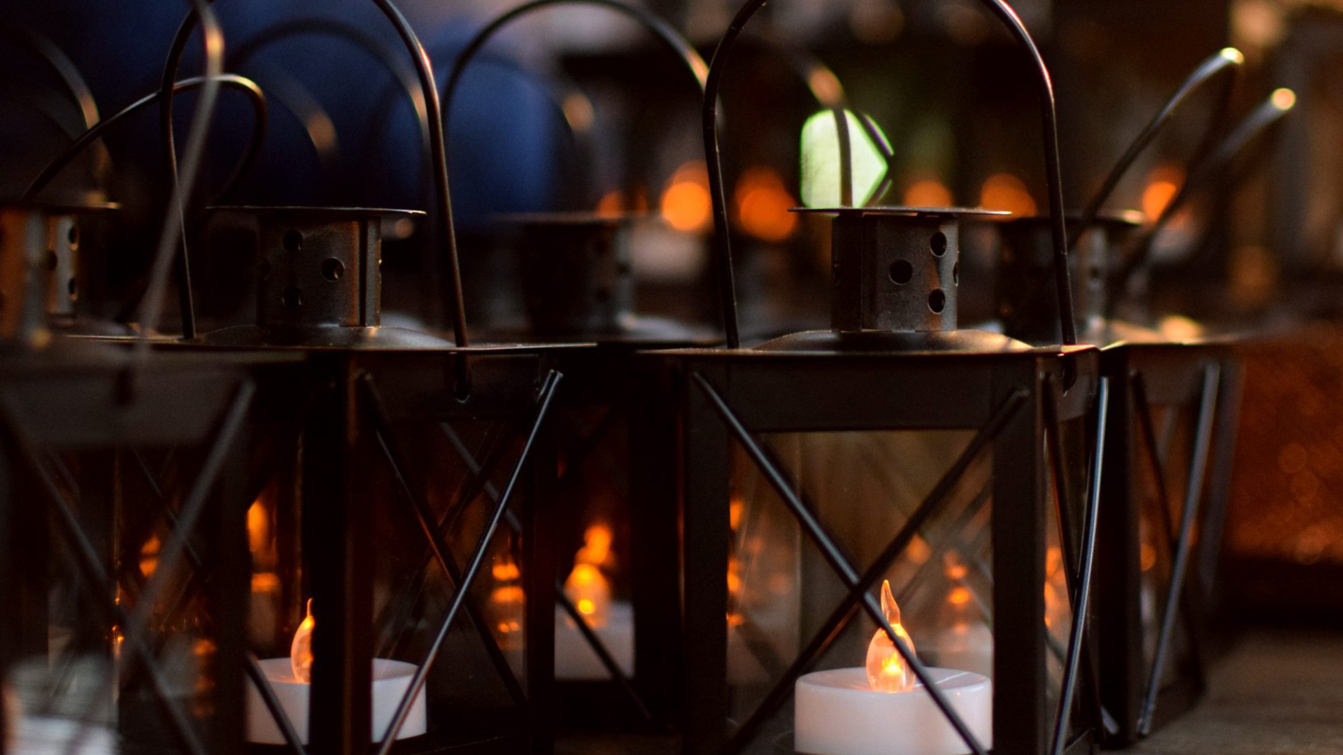 Rows of black lanterns with glowing candles shine with lively warmth, sparking creativity and togetherness in Essex County.