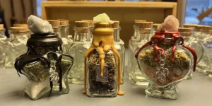 Colorful glass bottles brimming with herbs and stones, sealed in vibrant wax, showcase Essex County's creative community spirit.