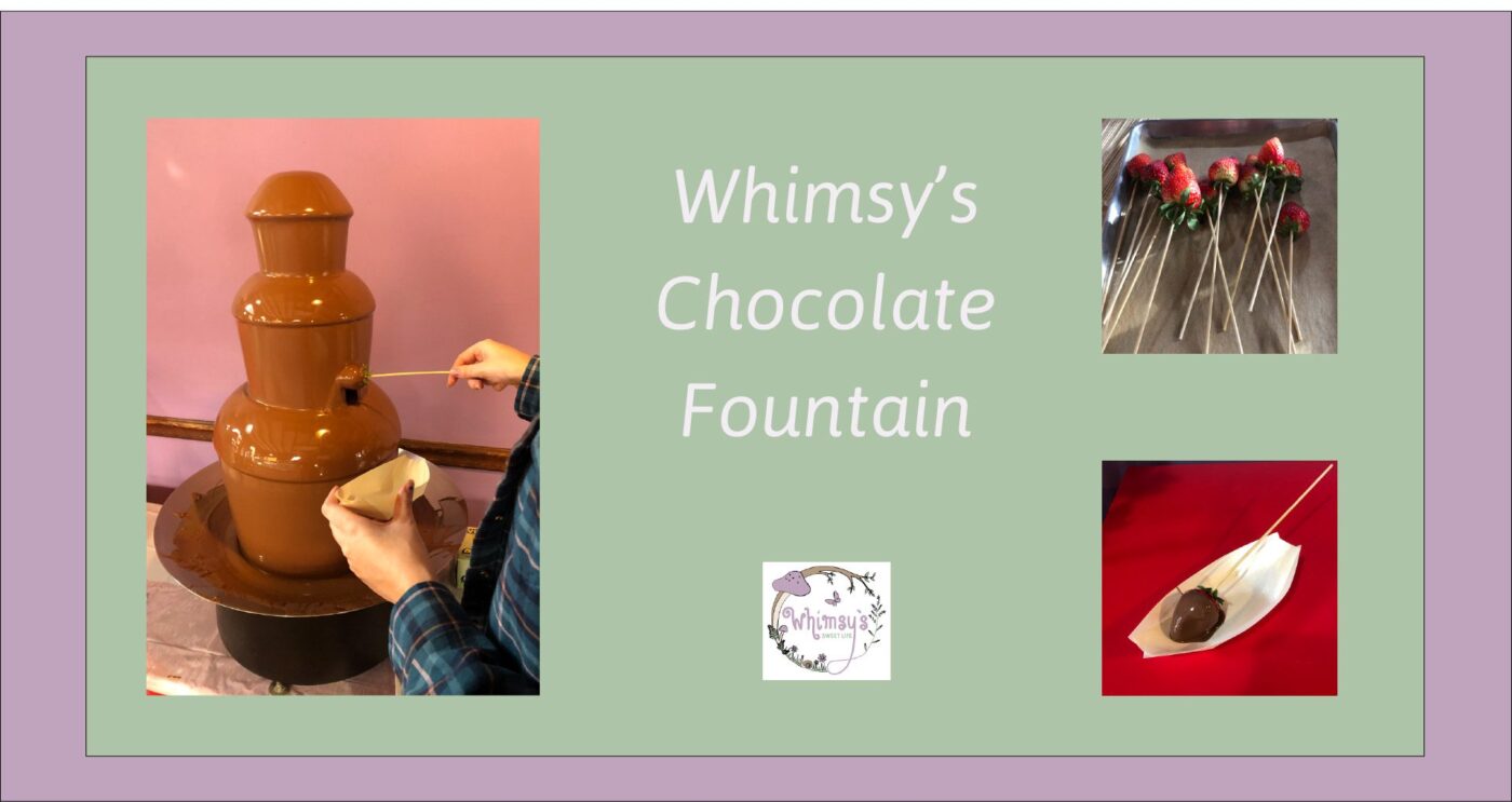 A hand dips a skewer into a lively chocolate fountain, with vibrant strawberries nearby—sweet fun uniting Essex County at Whimsy’s.