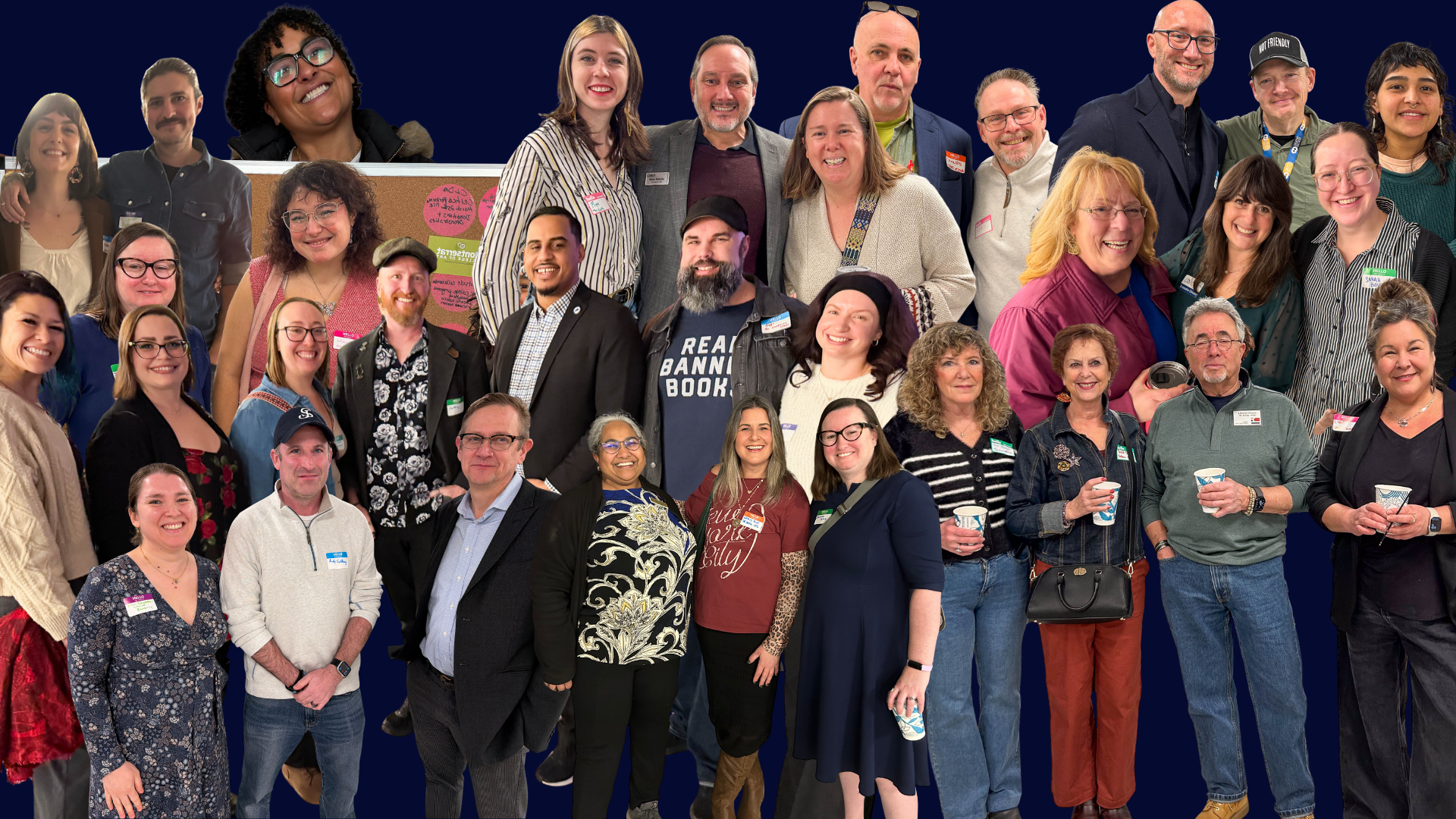 Around 30 adults of all backgrounds beam in a lively group photo, name tags and cups in hand, celebrating Essex County's vibrant community.