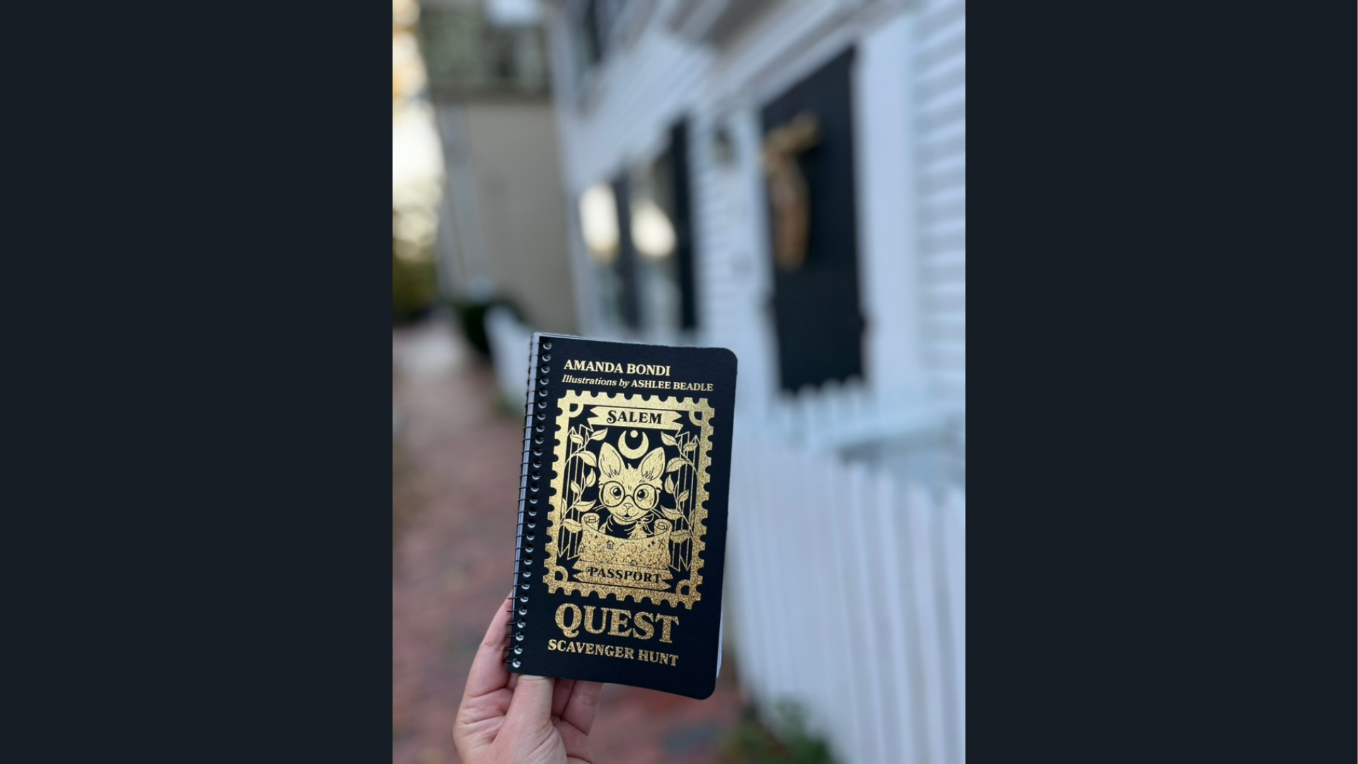A hand proudly displays a Salem Passport Quest booklet, symbolizing local adventure and vibrant Essex County community spirit.