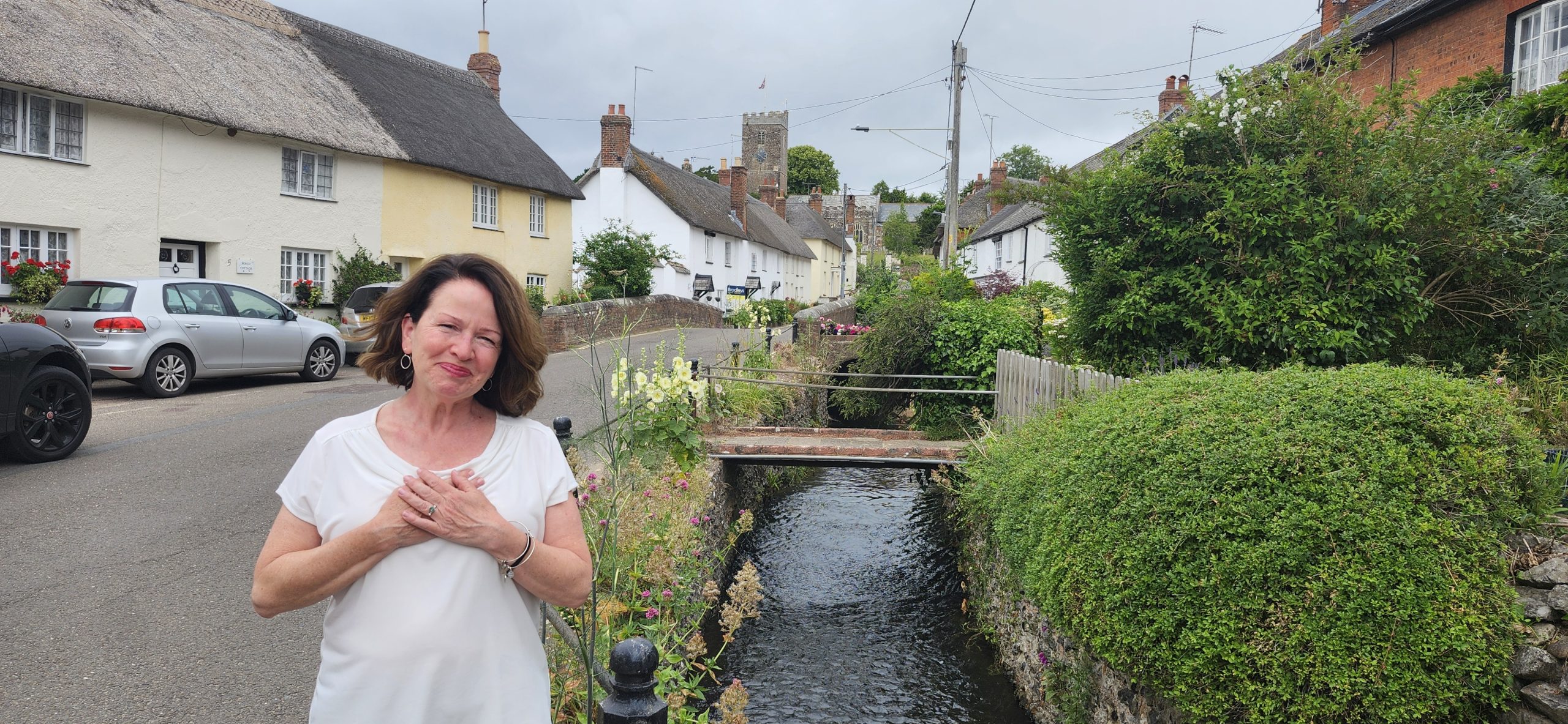 A lively North Shore village in Essex County, where community thrives—cottages, a church tower, and lush canals inspiring connection.