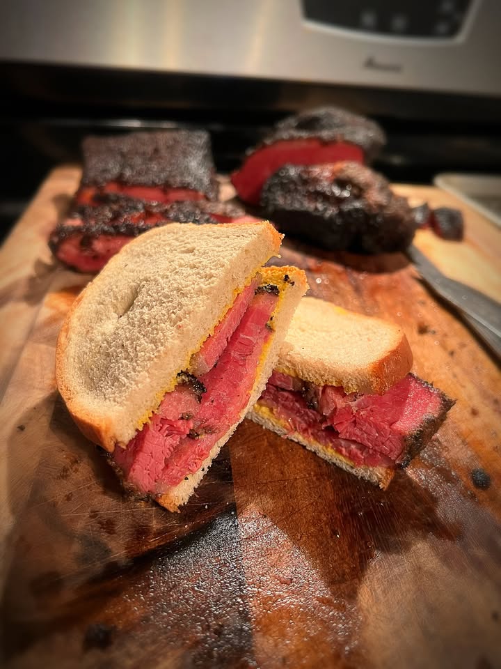 A vibrant sandwich with thick pink meat and seasoned crust on white bread, showcasing North Shore's creative flavors and Essex County pride.