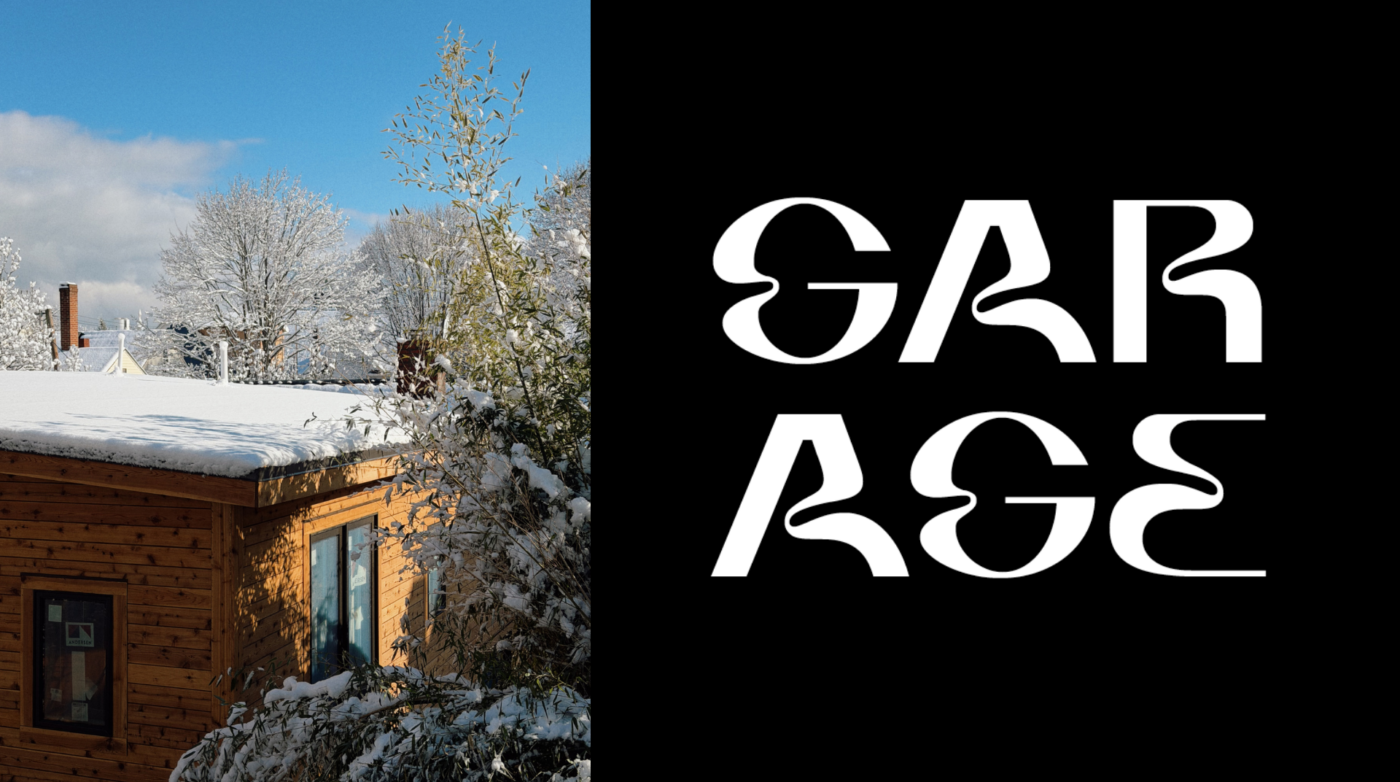 A wooden house with a snow-covered roof sits among snow-laden trees under a blue sky. Nearby, "Airtight Garage" is boldly displayed in large, stylized white letters against a black background.