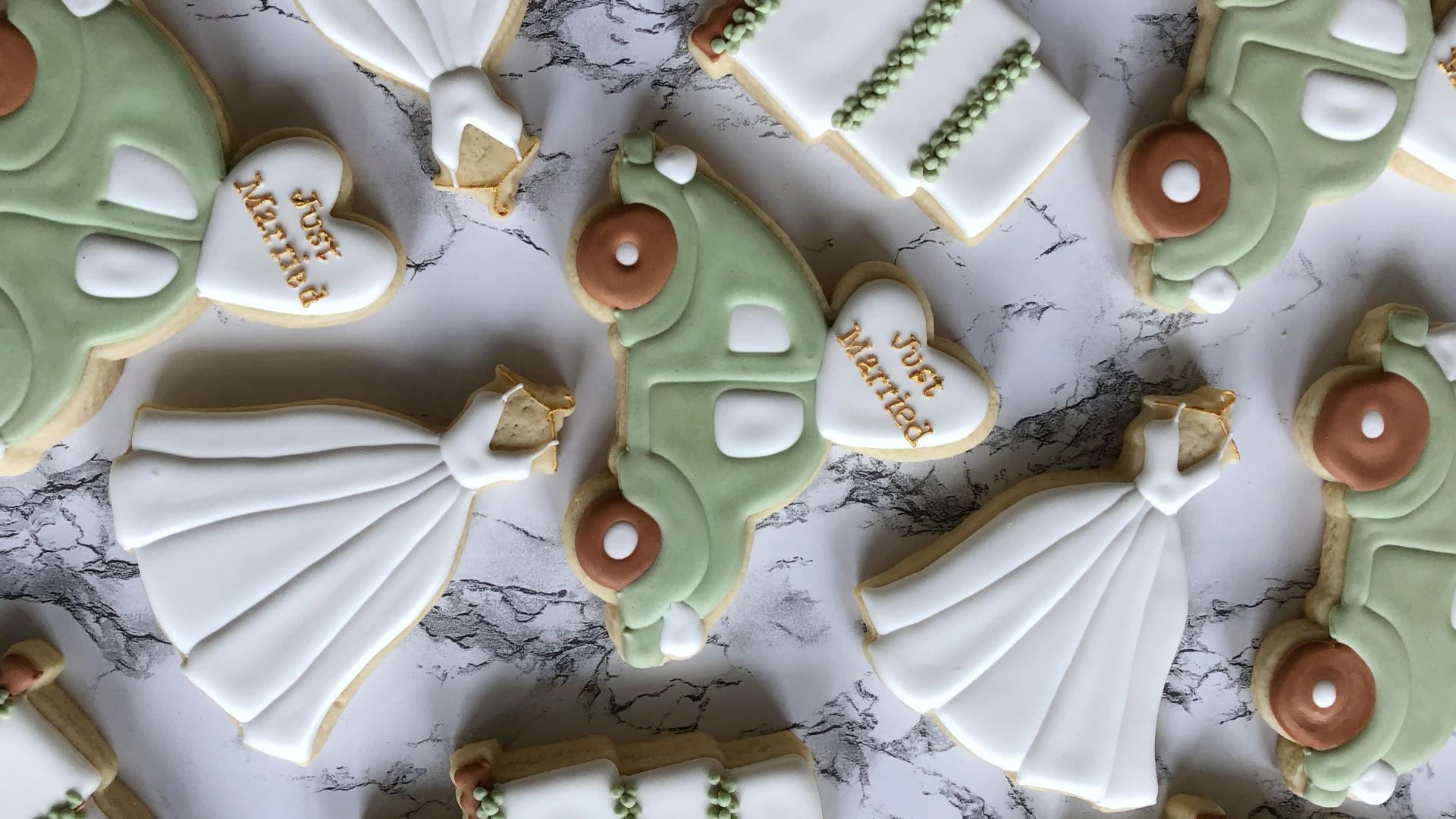 Colorful iced cookies—wedding dresses, vintage cars, cakes, and “Just Married” hearts—gather in a sweet display for Essex County’s creative community celebrations at Rusty's Recording Studio.