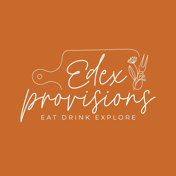 A lively orange logo with a cutting board, fork, and flower celebrates Edex provisions—inviting Essex County to eat, drink, and explore together.