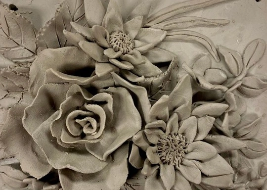 Vibrant clay sculpture of three gray flowers with rich detail, crafted by Salem MA artists uplifting our creative Essex County community.