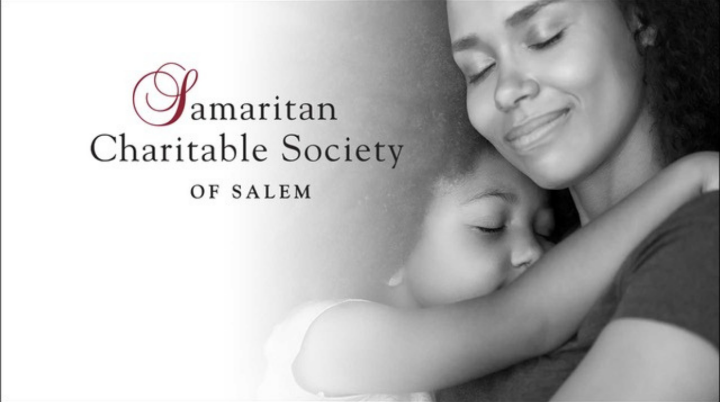 A black and white image shows a woman hugging a child with eyes closed. To the left, the text reads, “Samaritan Charitable Society of Salem.” Both appear calm and peaceful, reflecting the caring mission of this charitable society in Salem.