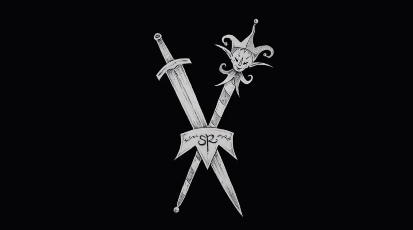 Two crossed daggers on a black background; one has a straight blade, and the other has a jester’s head as the pommel. A ribbon with "SR" and decorative writing—evoking the spirit of Salem RenFaire—is draped over the intersection.
