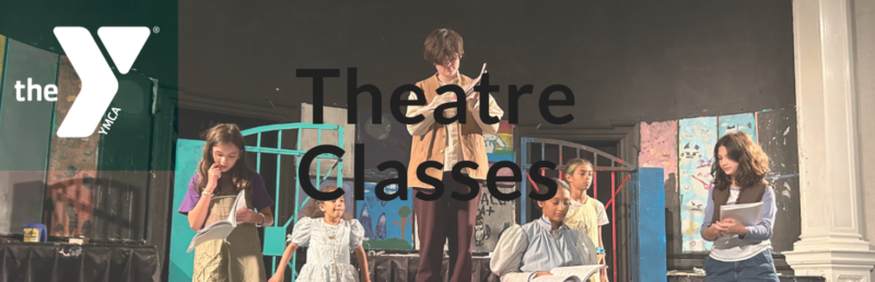 A group of children in costume perform a scene on stage, reading scripts. The background features painted set pieces. The YMCA logo and the text "Theatre Classes & Youth Vocal Ensemble" are overlaid on the image.