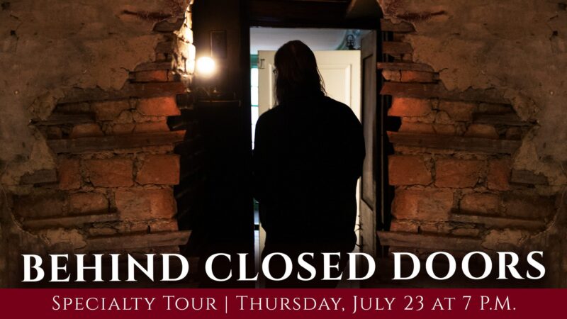 A person with long hair stands facing an open door in a dimly lit, brick-walled room. Text at the bottom reads, "BEHIND CLOSED DOORS Specialty Tour | Thursday, July 23 at 7 P.M.
