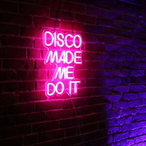 A pink neon sign on a brick wall in the heart of Essex County displays "DISCO MADE ME DO IT," casting a vibrant pink glow and hints of purple—perfect for those who live for CCE Nightlife.
