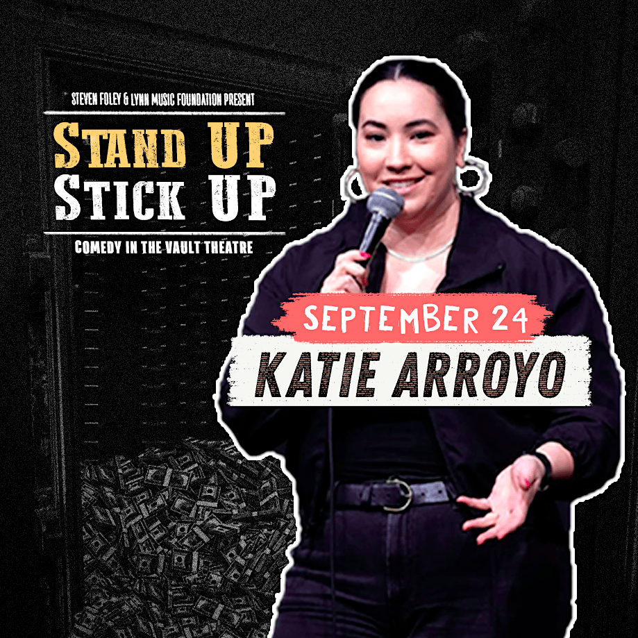 A woman holds a microphone and smiles on stage. Text reads: "Stand Up Stick Up—Comedy in the Vault Theatre. September 24. Katie Arroyo." Money bags are seen in the background. Presented by Steven Foley & LVNA Music Foundation.