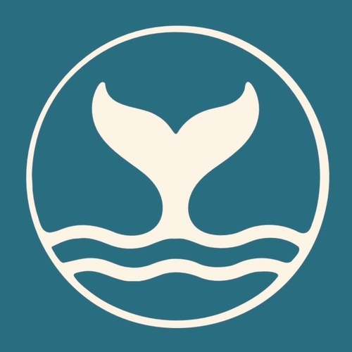 A white whale tail above three wavy lines, all enclosed in a white circle, is shown on a blue background.