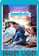 A man in a suit and sunglasses is shocked as a doll in a trash can explodes with garbage. The poster reads "The Garbage Pail Kids Movie," set on an Essex County city street. Bottom text: "Night Light.