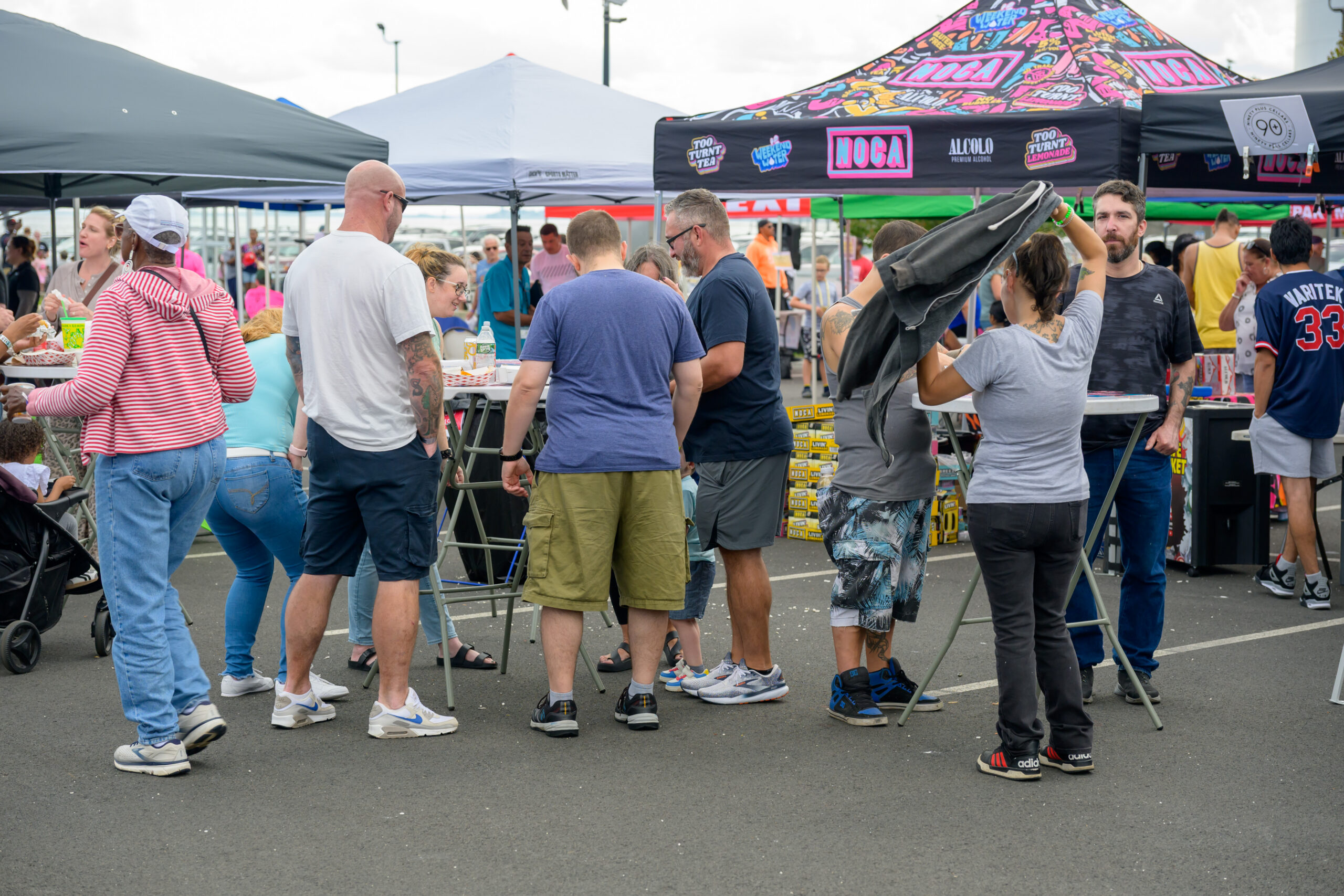 Festivalgoers gather around beverage tents during the 2025 Lynn waterfront food truck festival.