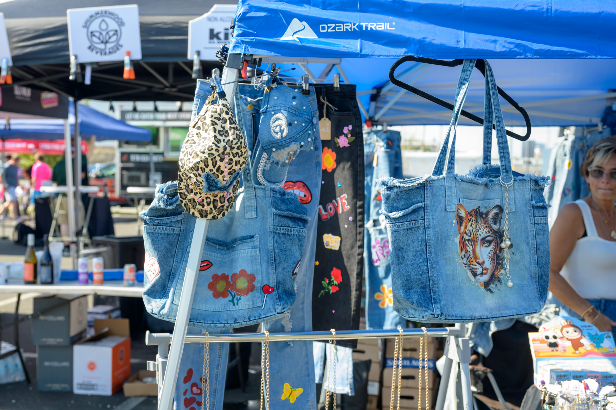 Upcycled denim bags and clothing displayed by an artisan vendor at the 2025 Lynn festival.