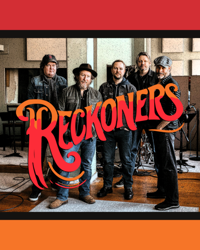 Five men stand together in a recording studio with instruments in the background. All are wearing jeans and jackets. The word “Reckoners” in large, stylized red and orange letters appears across the center of the image.