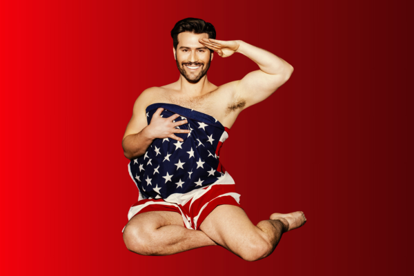 A man kneels on one knee, saluting, with a smiling expression. He is wrapped in an American flag, covering his body from chest to upper thigh. The background is a solid red gradient.